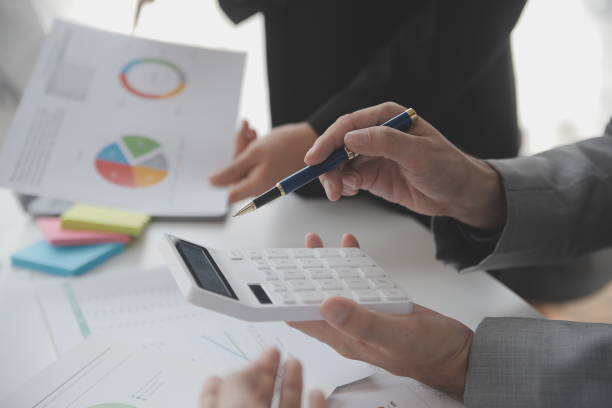istock Financial analysts analyze business financial reports on a digital tablet planning investment project during a discussion at a meeting of corporate showing the results of their successful teamwork. 1638248977
