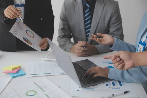 istock Financial analysts analyze business financial reports on a digital tablet planning investment project during a discussion at a meeting of corporate showing the results of their successful teamwork. 1638252387
