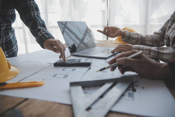 istock Construction and structure concept of engineer working drawing on blueprint meeting for project working with partner on model building and engineering tools in working site, construction concept. 1638270960