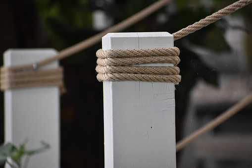 Jute ropes attached to white wooden poles