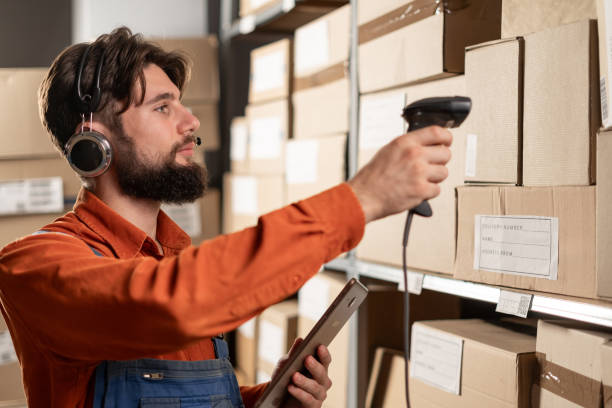 Warehouse manager with barcode reader and tablet PC. Inventory control. Warehouse manager with barcode reader and tablet PC. Inventory control. Copy space traceability stock pictures, royalty-free photos & images