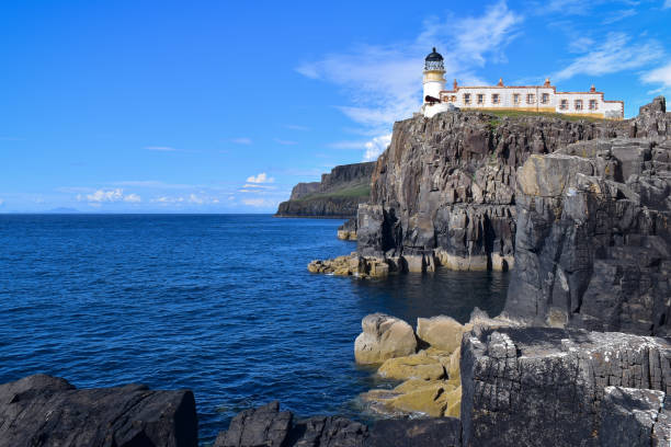 istock Neist Point Lighthouse high on basalt rock cliffs, Isle of Skye, Scotland 1638295559