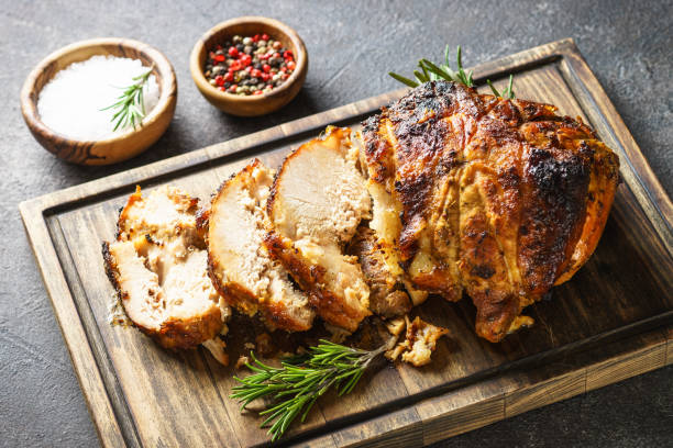 istock Baked ham on cutting board at dark. 1638299866