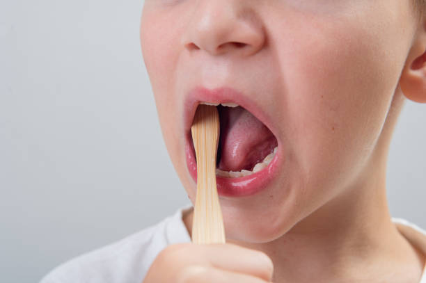 istock 7-year-old boy without one milk tooth brushes his teeth with a bamboo brush 1638300428