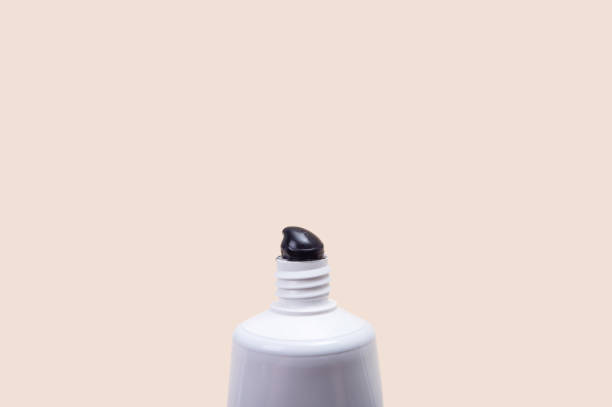 istock White tube with black toothpaste on a beige background. 1638300432