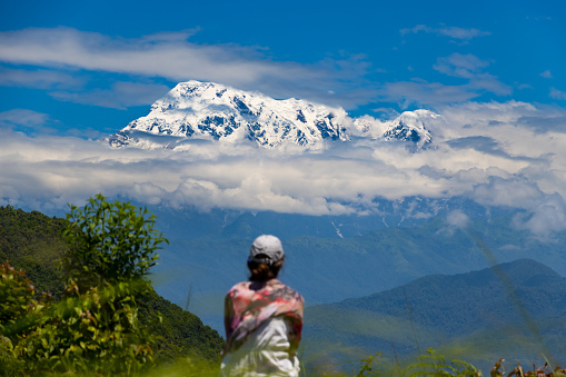 A woman views Mt. Annapurna and Fishtail from Sarangkot of Pokhara in Nepal