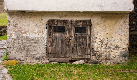A door in an abandoned building in the mountain village of Magnanins near Rigolato in Carnia, Friuli-Venezia Giulia, north east Italy