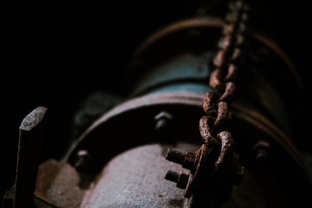 istock Rusty pipe and hanging on a rusty chain from an old factory 1638394793