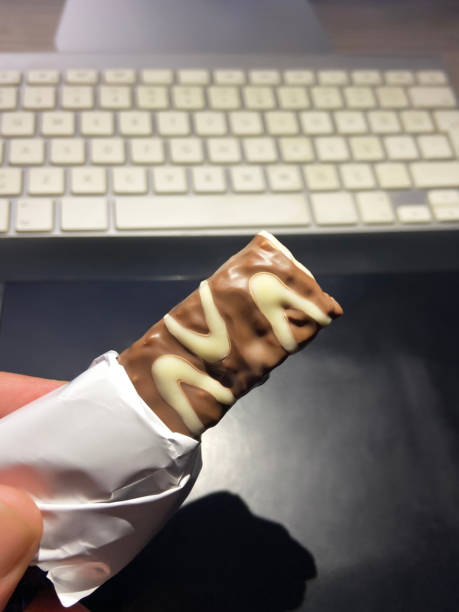 Macro photo of Chocolate bar. Broken pieces over white background.