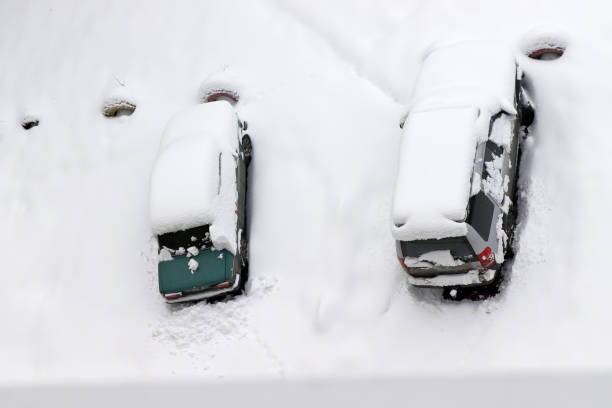 istock A car is shown in a parking lot covered with a snow layer. 1638429130