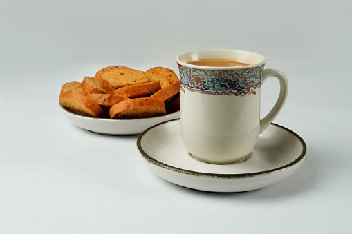 Milk tea with butter rusk bread. Tea with rusk. karak Chai isolated on white background