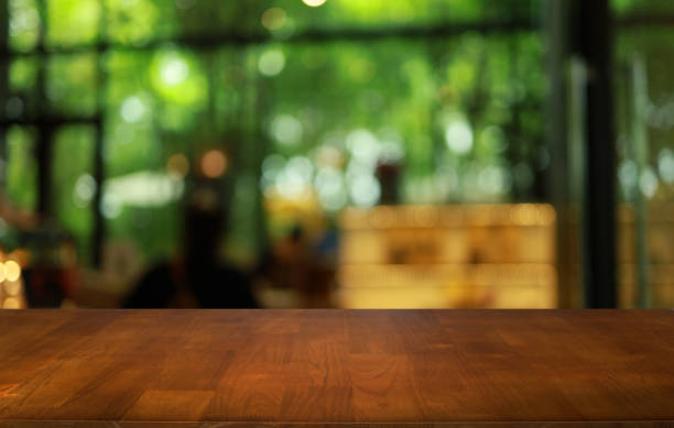 istock Wood table top in front of abstract blurred background. Empty wooden table space for text marketing promotion. blank wood table surface copy space 1638451370
