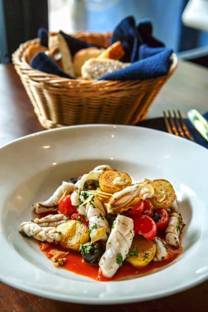 istock Squid stew with baby potato and baby tomatoes 1638458786