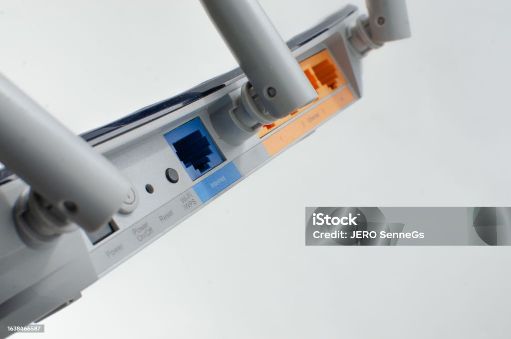 Close-up detail of a modern Wi-Fi router, with multiple inputs and ports for cable connections, representing internet technology and connections. Close-up detail of a modern Wi-Fi router, with multiple inputs and ports for cable connections, representing internet technology and connections Black Color Stock Photo Close-up detail of a modern Wi-Fi router, with multiple inputs and ports for cable connections, representing internet technology and connections. Close-up detail of a modern Wi-Fi router, with multiple inputs and ports for cable connections, representing internet technology and connections Black Color Stock Photo