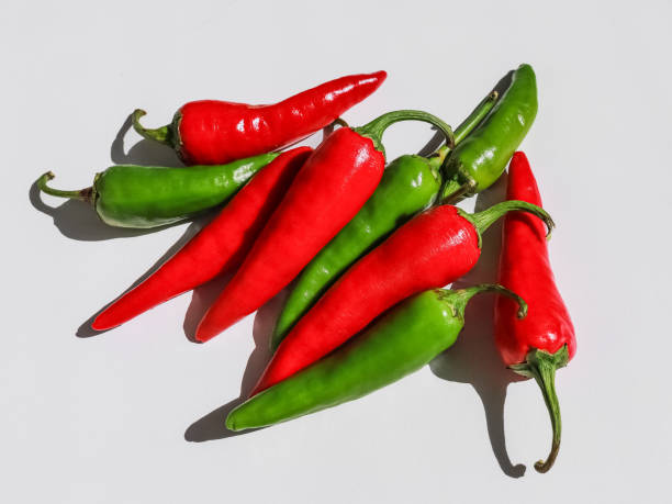 istock Hot red and green peppers on a white background 1638482004