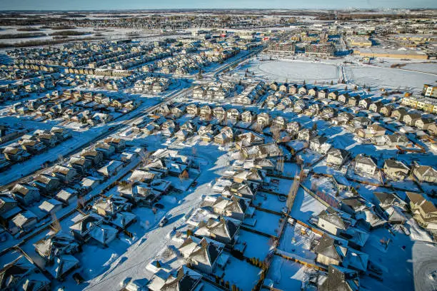 Aerial view of Stonebridge which is a mostly residential neighbourhood located in south-central Saskatoon, Saskatchewan, Canada. It is a suburban subdivision, consisting of low-density, single detached dwellings and a mix of medium-density apartment and semi-detached dwellings.