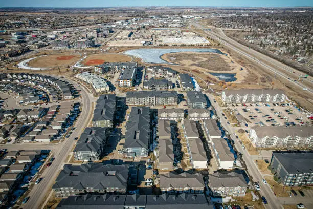 Aerial view of Stonebridge which is a mostly residential neighbourhood located in south-central Saskatoon, Saskatchewan, Canada. It is a suburban subdivision, consisting of low-density, single detached dwellings and a mix of medium-density apartment and semi-detached dwellings.