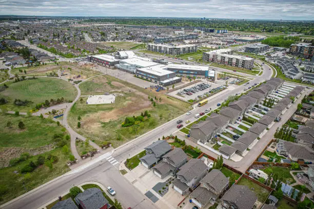 Aerial view of Stonebridge which is a mostly residential neighbourhood located in south-central Saskatoon, Saskatchewan, Canada. It is a suburban subdivision, consisting of low-density, single detached dwellings and a mix of medium-density apartment and semi-detached dwellings.