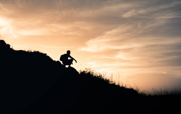 istock Young thoughtful man on a mountain enjoys the sunrise view. 1638508030