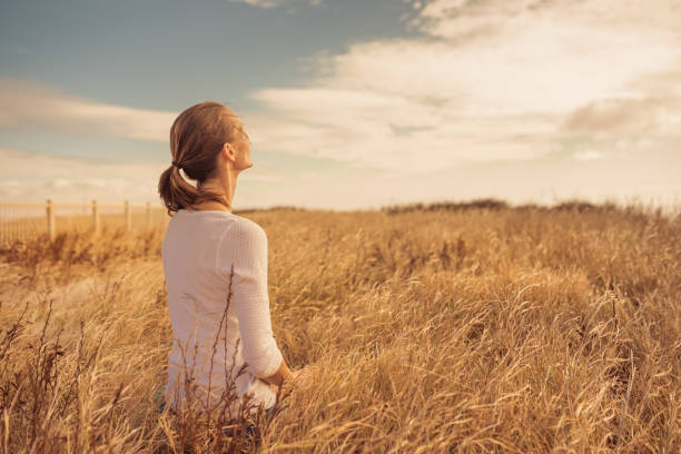 istock Young women with joy and inspiration facing the sun. 1638508552