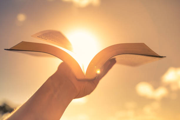 istock Open book bible up to the sun light. Religion, education and knowledge concept. 1638509098