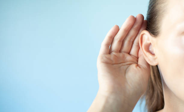 istock Girl listening with hand on ear.  Hearing problem. 1638509124