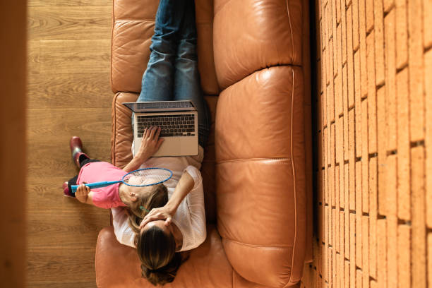 istock Tired mother trying to work on a laptop at home while watching child. 1638514890
