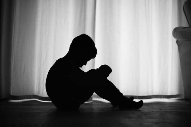 istock Sad little boy sitting on the floor at home. 1638515551