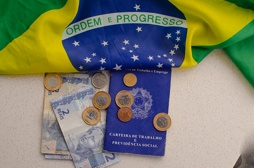 Brazil Work Card. Translation - Federative Republic of Brazil, Ministry of Labor. Brazil work card with money on the side. symbolizing the importance of employment and finance.