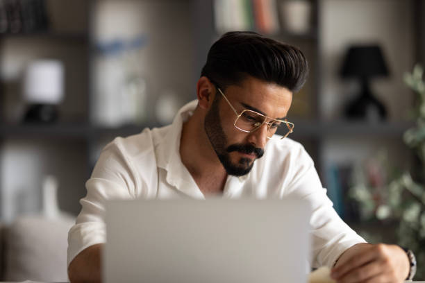 istock Young man working at home in the evening 1638523979