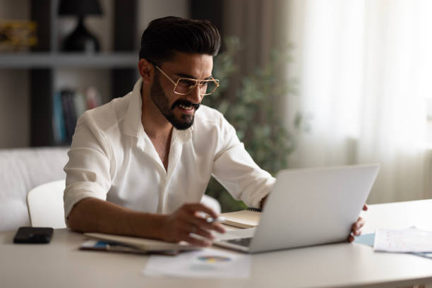 istock Smiling young man working at home 1638527750