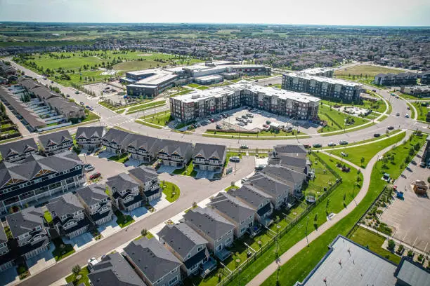 Aerial view of Stonebridge which is a mostly residential neighbourhood located in south-central Saskatoon, Saskatchewan, Canada. It is a suburban subdivision, consisting of low-density, single detached dwellings and a mix of medium-density apartment and semi-detached dwellings.