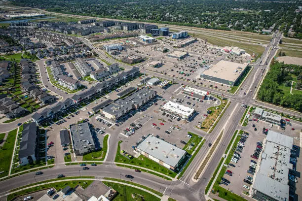 Aerial view of Stonebridge which is a mostly residential neighbourhood located in south-central Saskatoon, Saskatchewan, Canada. It is a suburban subdivision, consisting of low-density, single detached dwellings and a mix of medium-density apartment and semi-detached dwellings.