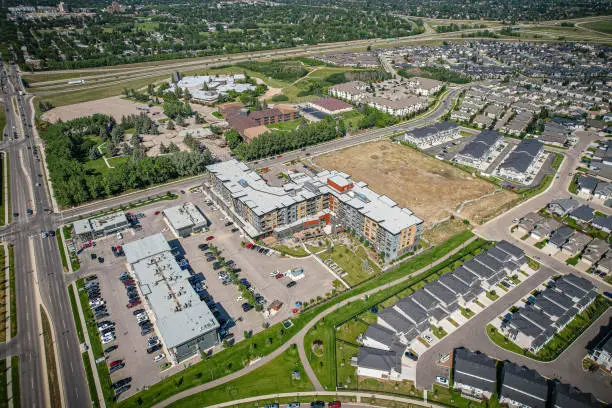 Aerial view of Stonebridge which is a mostly residential neighbourhood located in south-central Saskatoon, Saskatchewan, Canada. It is a suburban subdivision, consisting of low-density, single detached dwellings and a mix of medium-density apartment and semi-detached dwellings.