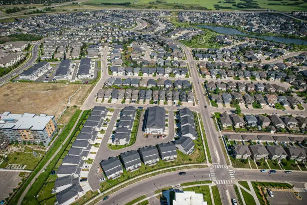 Aerial view of Stonebridge which is a mostly residential neighbourhood located in south-central Saskatoon, Saskatchewan, Canada. It is a suburban subdivision, consisting of low-density, single detached dwellings and a mix of medium-density apartment and semi-detached dwellings.