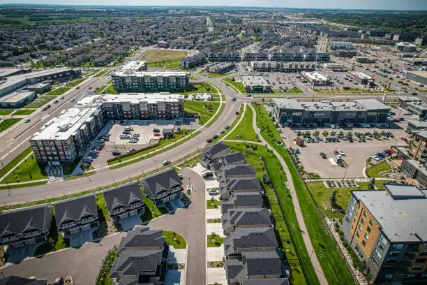 Aerial view of Stonebridge which is a mostly residential neighbourhood located in south-central Saskatoon, Saskatchewan, Canada. It is a suburban subdivision, consisting of low-density, single detached dwellings and a mix of medium-density apartment and semi-detached dwellings.