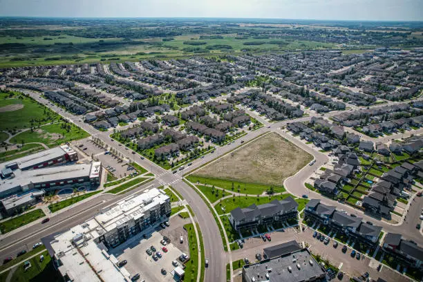 Aerial view of Stonebridge which is a mostly residential neighbourhood located in south-central Saskatoon, Saskatchewan, Canada. It is a suburban subdivision, consisting of low-density, single detached dwellings and a mix of medium-density apartment and semi-detached dwellings.