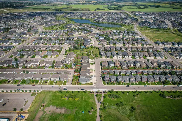 Aerial view of Stonebridge which is a mostly residential neighbourhood located in south-central Saskatoon, Saskatchewan, Canada. It is a suburban subdivision, consisting of low-density, single detached dwellings and a mix of medium-density apartment and semi-detached dwellings.