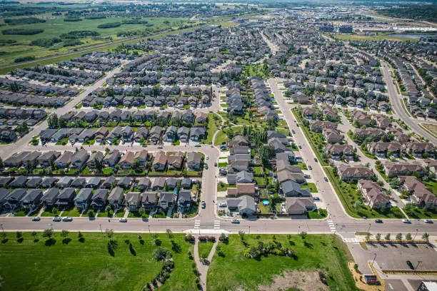 Aerial view of Stonebridge which is a mostly residential neighbourhood located in south-central Saskatoon, Saskatchewan, Canada. It is a suburban subdivision, consisting of low-density, single detached dwellings and a mix of medium-density apartment and semi-detached dwellings.
