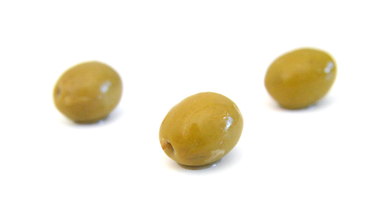 green marinated olives isolated on white background