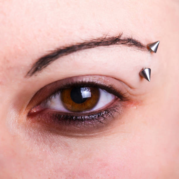 eye - augenbrauenpiercing stock-fotos und bilder