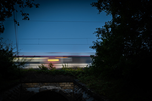 Passenger train on railroad tracks at night, High quality photo