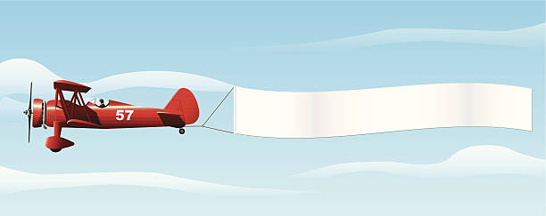 Biplane with Banner A biplane flying with a blank banner, includes AI CS file words in the sky stock illustrations