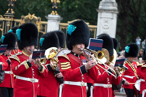 LONDON, UNITED KINGDOM -  4 AUGUSTUS  2023: officers and soldiers of the coldstream guards march in front of buckingham palace during the changing of the guard ceremony
