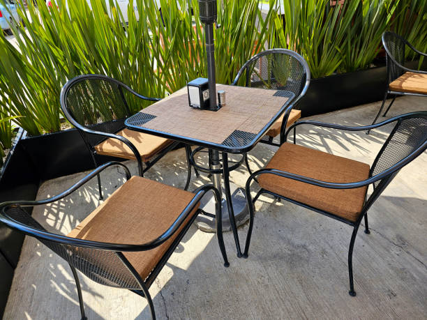 istock brown chairs outside green grass on the back and table 1638601889
