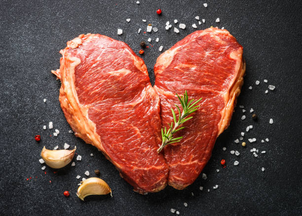 istock Beef steak. Raw beef meat at black. 1638623575