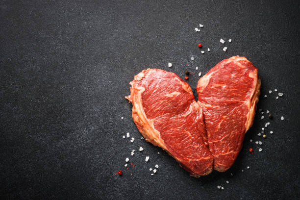 istock Beef steak. Raw beef meat at black. 1638623581