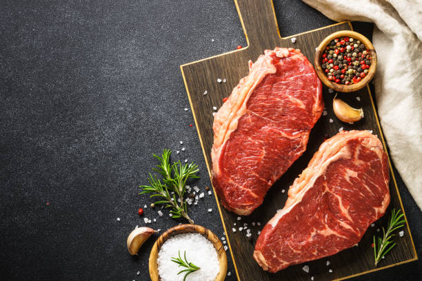 istock Beef steak. Raw beef meat at black. 1638624624