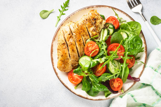 istock Green salad with chicken fillet on white. 1638626268