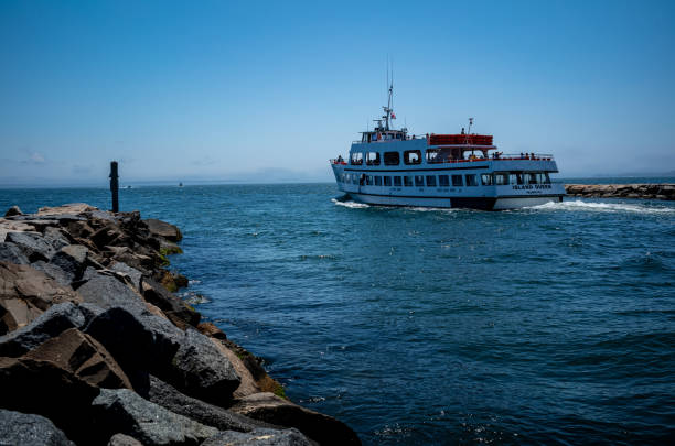 A variety of boats entering and leaving Falmouth Harbor in Falmouth, MA on Cape Cod.  A Busy harbor, there is a constant flow of boats including the Island Queen ferry out of the harbor into Vineyard Sound.